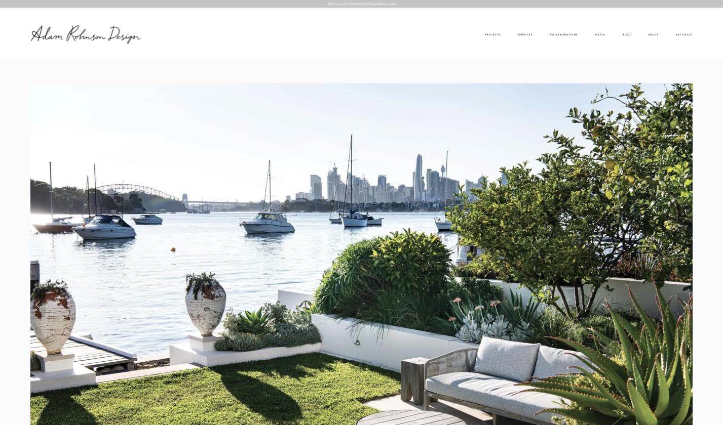 Adam Robinson Design homepage — a Sydney Harbour rooftop garden with boats and the city skyline behind a lush, considered planting scheme