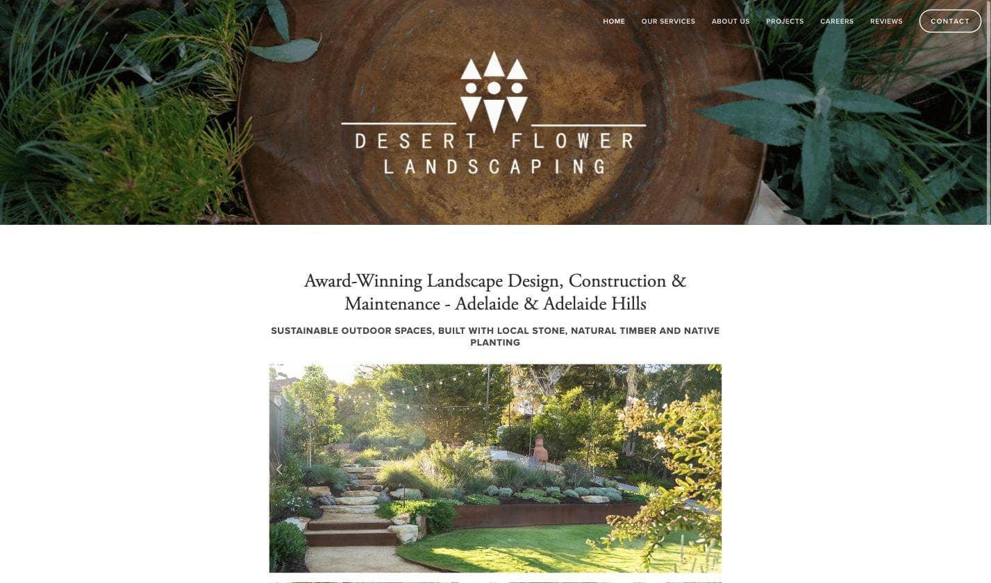Desert Flower Landscaping homepage — a terraced native garden with sandstone steps, string lights and lush South Australian planting at golden hour